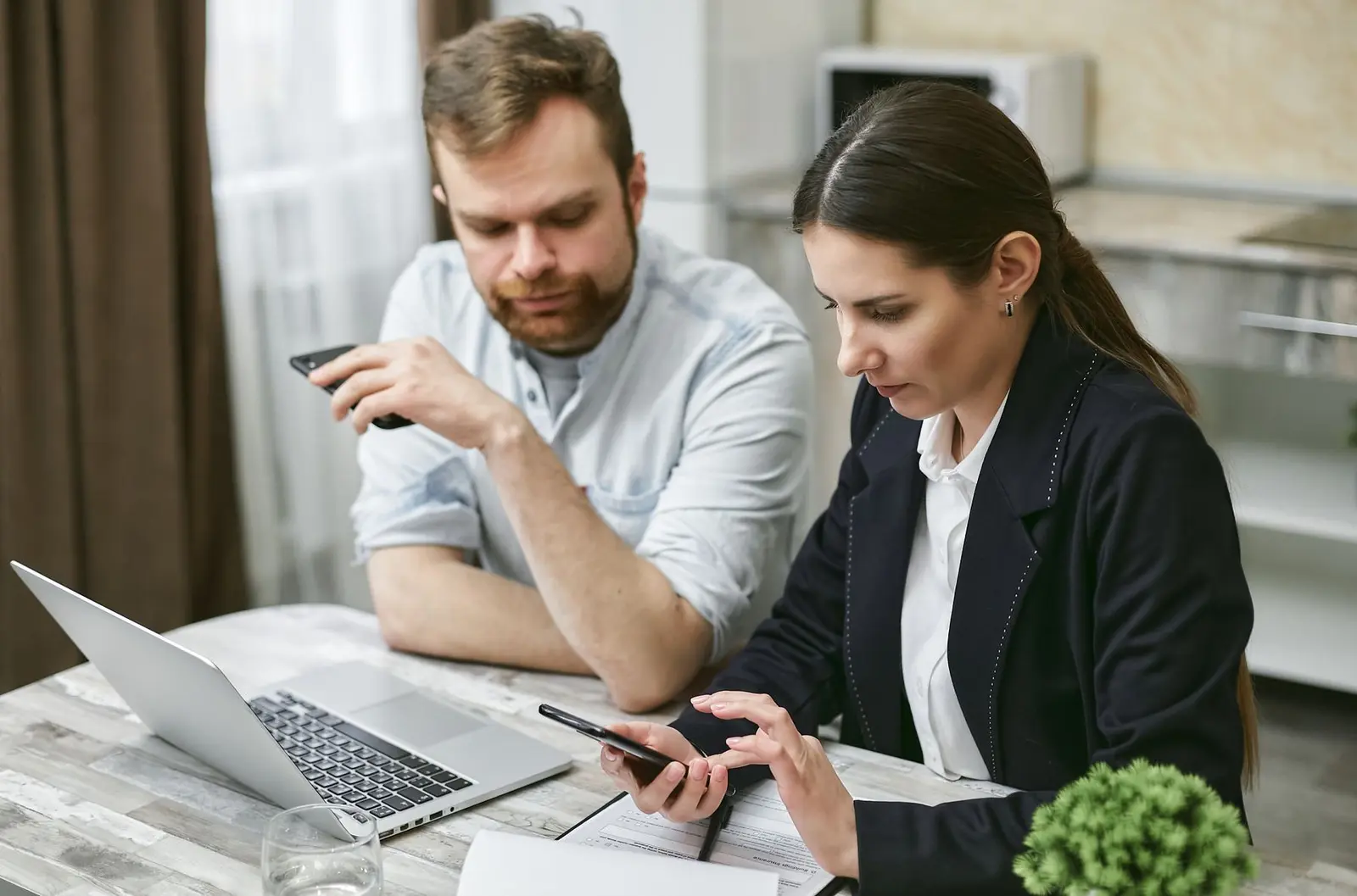 People working with business information on a laptop
